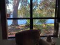Relaxing lake view from inside condo with comfortable seating and large window at 3480 Hillmoor Dr, Palm Harbor, FL 34685