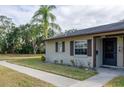 Tan house with brown roof, walkway, and landscaping at 4215 E Bay Dr # 104, Clearwater, FL 33764