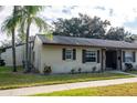 Tan house with brown roof and landscaping at 4215 E Bay Dr # 104, Clearwater, FL 33764