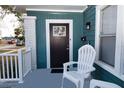 Dark brown front door with a sidelight window at 4820 8Th S Ave, St Petersburg, FL 33711