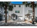 Front view of a gray townhouse with a white door at 514 Ryans Woods Ln, Palm Harbor, FL 34683