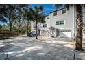 Gray townhouse with a private driveway and palm trees at 514 Ryans Woods Ln, Palm Harbor, FL 34683