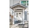 White front door with a decorative arch and sidelights at 514 Ryans Woods Ln, Palm Harbor, FL 34683