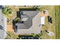 Top-down view of a single-story house, showing roofline and landscaping at 725 Winterbrooke Way, Sun City Center, FL 33573