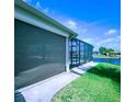 The screened lanai has access to the canal, and features brick pavers and a retractable sun shade at 8680 Quinn Ct, North Port, FL 34287