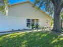 Side view of home with lush lawn and mature tree at 9022 Ramsgate Dr # 9022, New Port Richey, FL 34655