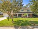 Charming two-story residence with a brick and siding exterior and front yard at 10114 Lindelaan Dr, Tampa, FL 33618