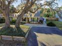 Single-story house with large tree and paved driveway at 1141 Dover Ct, Safety Harbor, FL 34695