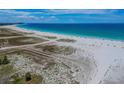 Expansive beach with clear water and blue sky at 11605 Gulf Blvd # 502, Treasure Island, FL 33706