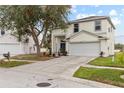 Two-story house with a two-car garage and nicely landscaped yard at 13222 Pike Lake Dr, Riverview, FL 33579