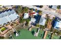 Aerial view of a home situated on a canal with docks and boats at 333 Bay Plz, Treasure Island, FL 33706