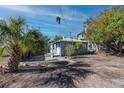 Backyard of a light blue home with a small concrete patio at 333 Bay Plz, Treasure Island, FL 33706