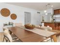 Elegant dining area with a wood table and neutral-toned chairs at 5558 Angelonia Ter, Land O Lakes, FL 34639