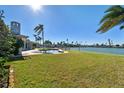 Spacious backyard with pool, dock, and scenic waterfront views at 568 Johns Pass Ave, Madeira Beach, FL 33708