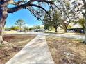 Residential street view with mature trees and neighborhood homes at 6700 14Th N St, St Petersburg, FL 33702