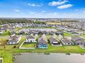 Community overview showcasing numerous homes, a lake, and desirable landscape at 11914 Wild Daffodil Ct, Riverview, FL 33579