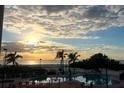 Relaxing pool area at sunset with beach views at 12000 Gulf Blvd # 212-N, Treasure Island, FL 33706