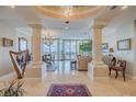 Spacious living room with water views and columns at 140 Riviera Dunes Way # 1001, Palmetto, FL 34221