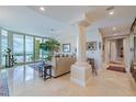 Spacious living room with water view and elegant furnishings at 140 Riviera Dunes Way # 1001, Palmetto, FL 34221