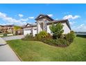 House exterior with stone accents and lush landscaping at 14426 Woodland Spur Dr, Lithia, FL 33547