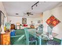 Dining area features a glass-top table and teal chairs at 2846 Pinellas Point S Dr, St Petersburg, FL 33712