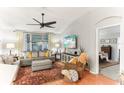 Bright living room with hardwood floors, large TV, and comfy furniture at 3022 Beaver Pond Trl, Valrico, FL 33596