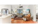 Spacious living room featuring hardwood floors and comfy seating at 3022 Beaver Pond Trl, Valrico, FL 33596