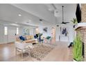 Bright living room with light hardwood floors, comfortable seating, and a fireplace at 107 17Th St, Belleair Beach, FL 33786