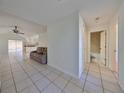 View of a hallway leading to living room and bathroom at 11 Leaning Palm Ct, Plant City, FL 33563