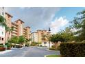 Exterior of condo building with lush landscaping and parking at 12055 Gandy N Blvd # 231, St Petersburg, FL 33702