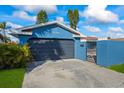 Attached garage with dark-colored door and gated entry at 1409 Ne 49Th Ne Ave, St Petersburg, FL 33703