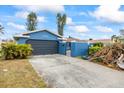 Blue house with a dark gray garage door at 1409 Ne 49Th Ne Ave, St Petersburg, FL 33703