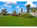 Large grassy yard with lush landscaping and mature trees at 1409 Ne 49Th Ne Ave, St Petersburg, FL 33703