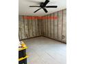 Empty living room with tiled floors and ceiling fan at 259 Medallion Blvd # B, Madeira Beach, FL 33708