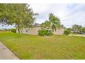 Side view of a house with solar panels and lush landscaping at 529 Laguna Mill Dr, Ruskin, FL 33570