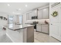 Modern kitchen featuring granite countertops and gray cabinets at 10058 Shoreline View Way, Wesley Chapel, FL 33545