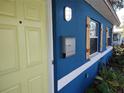 Blue house exterior with light-yellow door and wooden shutters at 1644 24Th N Ave, St Petersburg, FL 33713