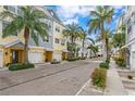 Community of townhouses with palm trees and a paved road at 3192 Nautical S Pl, St Petersburg, FL 33712