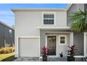 Two-story house with a gray exterior, white garage, and black front door at 3345 Pleasant Willow Ct, Brandon, FL 33511