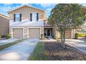 Tan two-story townhome with double garage at 4312 Silver Falls Dr, Land O Lakes, FL 34639