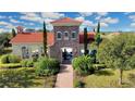 Community clubhouse with a red tile roof, stone accents, and outdoor patio area at 5317 Lake Venice Dr, Wimauma, FL 33598