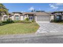 Two-story house with double doors and paver driveway at 8041 Green Pines Ter, Spring Hill, FL 34606