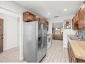 Modern kitchen with stainless steel appliances and wood-look flooring at 8755 Bardmoor Blvd # 105, Seminole, FL 33777