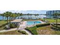 Community pool with lush landscaping and waterfront access at 9815 Harrell Ave # 302, Treasure Island, FL 33706