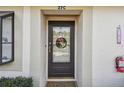 Close-up of the front door with decorative wreath and a visible smart lock at 11511 113Th St # 27C, Largo, FL 33778