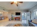 Living room features comfortable seating, a large TV, and access to a balcony at 18320 Gulf Blvd # 303, Redington Shores, FL 33708