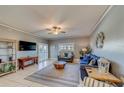 Spacious living room with comfortable seating, a large TV, and plenty of natural light at 18320 Gulf Blvd # 303, Redington Shores, FL 33708