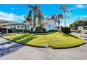 View of the home's exterior, showcasing its corner lot location and lush lawn at 2465 Northside Dr # 1808, Clearwater, FL 33761