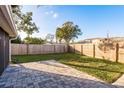 Spacious backyard with a patio and wooden privacy fence at 2713 Apia Pl, Holiday, FL 34691