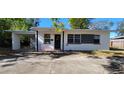 Front view of a charming house with a black and white color scheme at 3600 63Rd N Way, St Petersburg, FL 33710